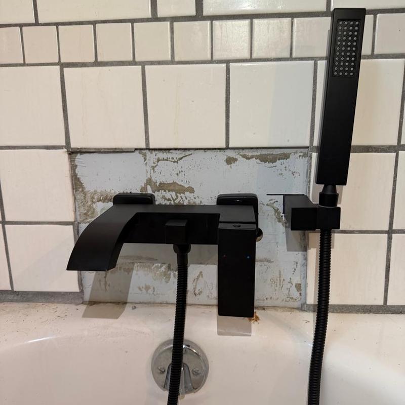 Bathtub shower valve installation with black fixtures
