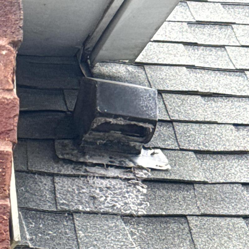 Roof-mounted dryer vent with damaged shingles