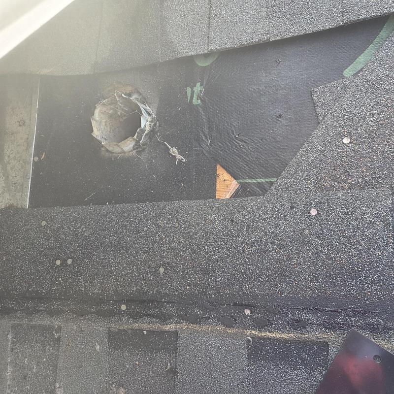 Roof-mounted dryer vent opening with removed shingles