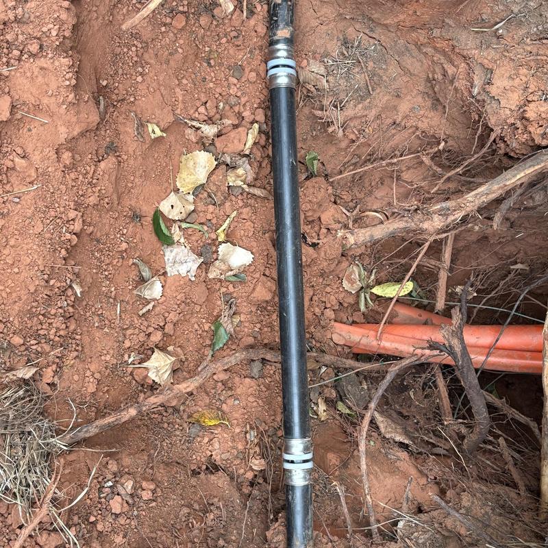 Main water service line with new fittings in excavated soil