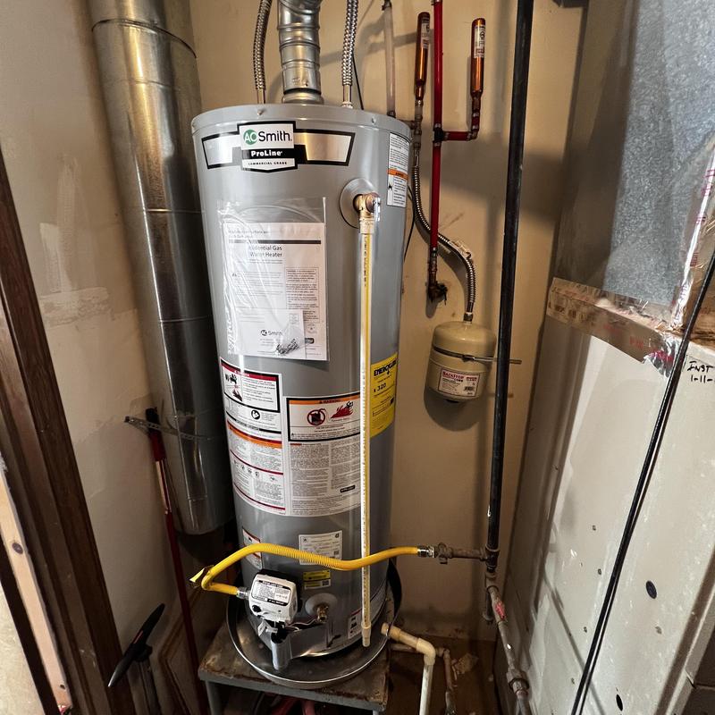 AO Smith natural gas water heater installation in utility room