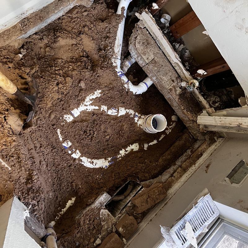 PVC sewer repipe installation in home floor excavation