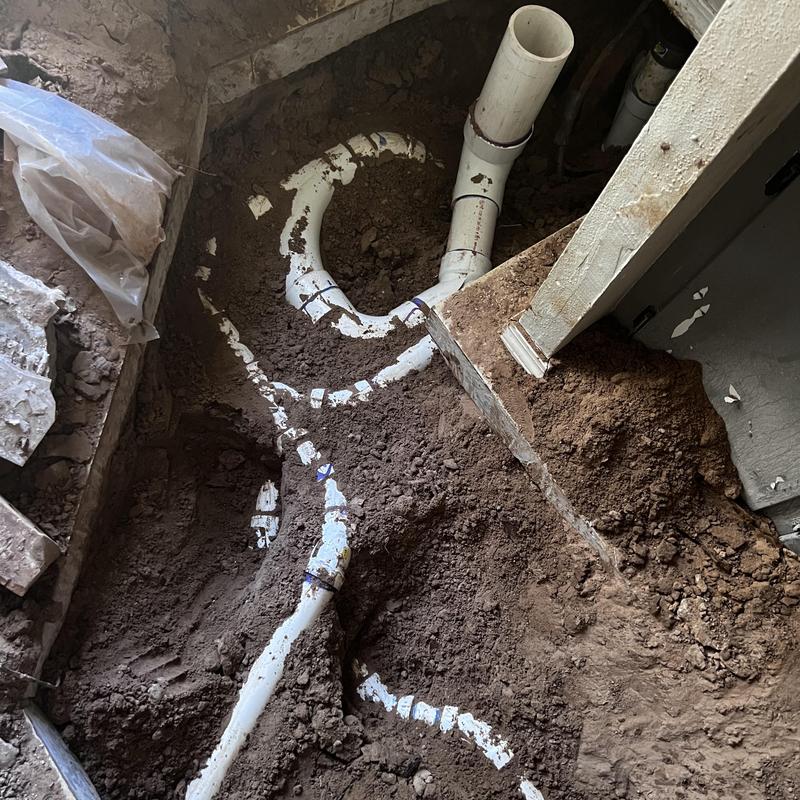 Sewer repipe with PVC piping in excavated floor