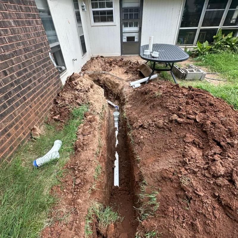 Sewer repipe trench with new PVC piping installation