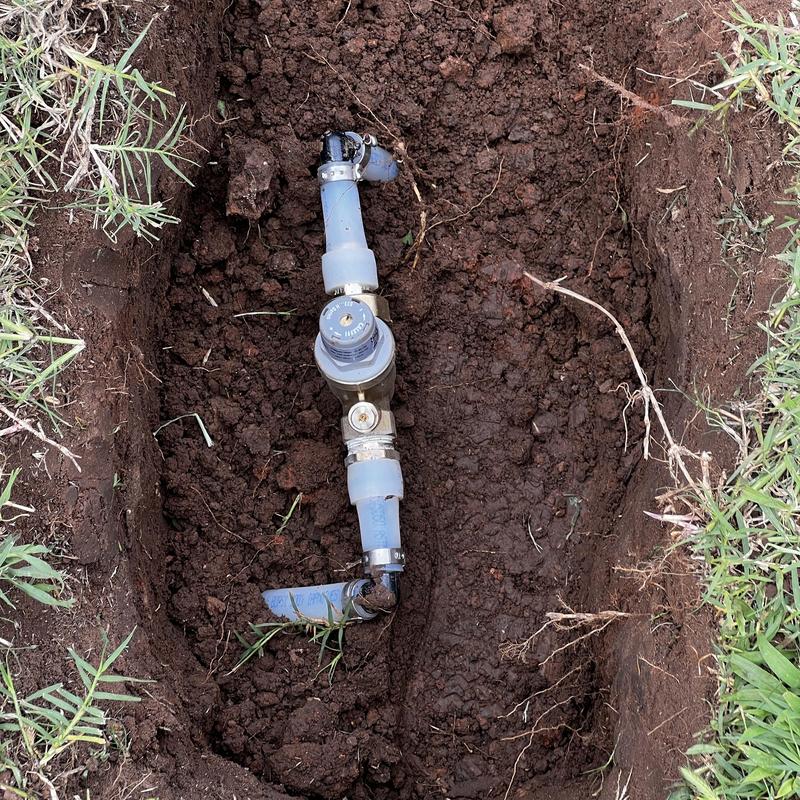Pressure reducing valve installation buried in soil trench