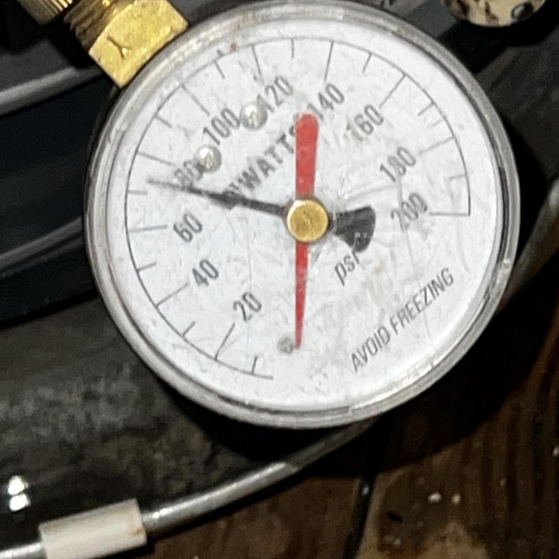 Water pressure gauge showing pressure reading at valve