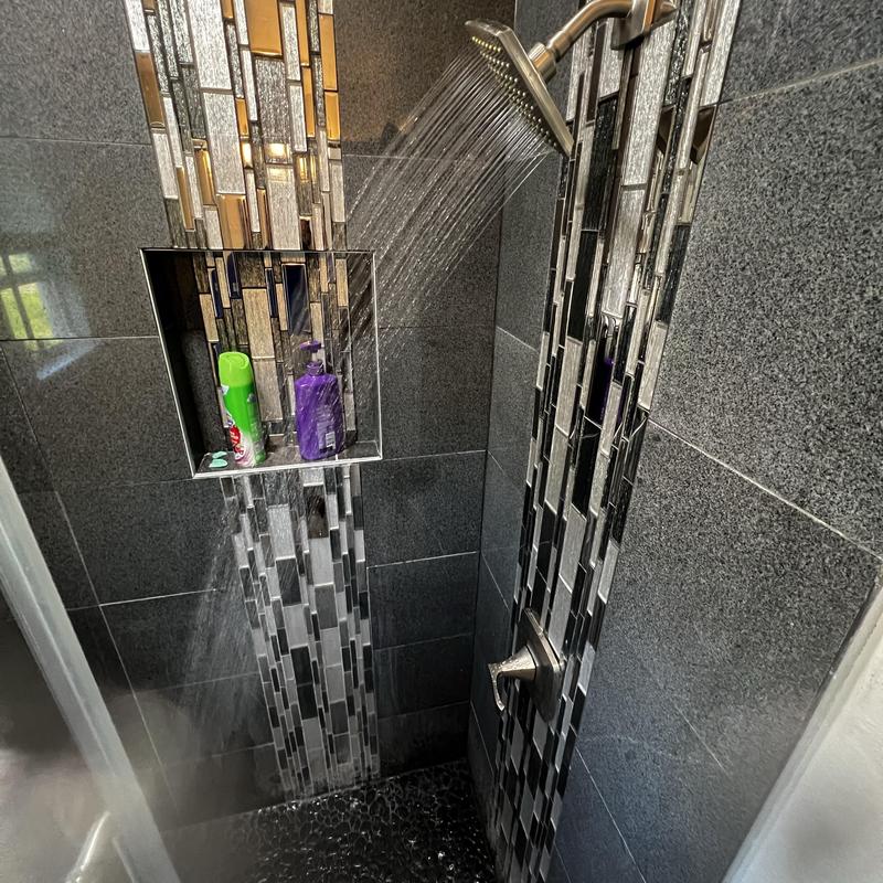 Shower trim with running water and tiled walls