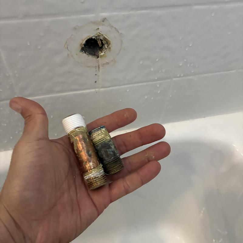 Shower valve pipe nipples showing old and new parts