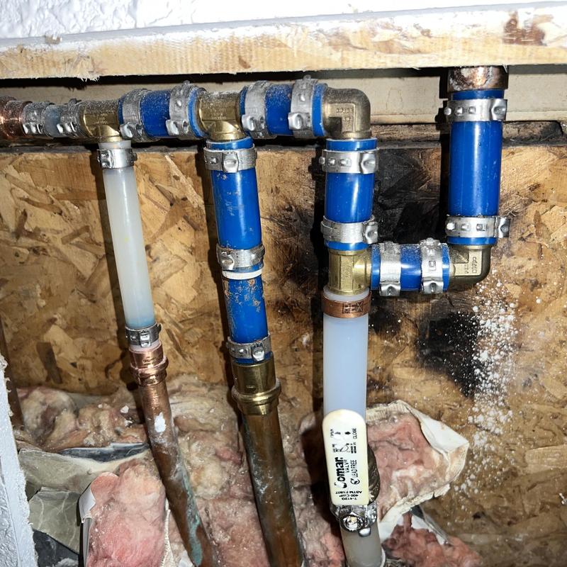 Blue PEX water line reroute under floor slab with fittings