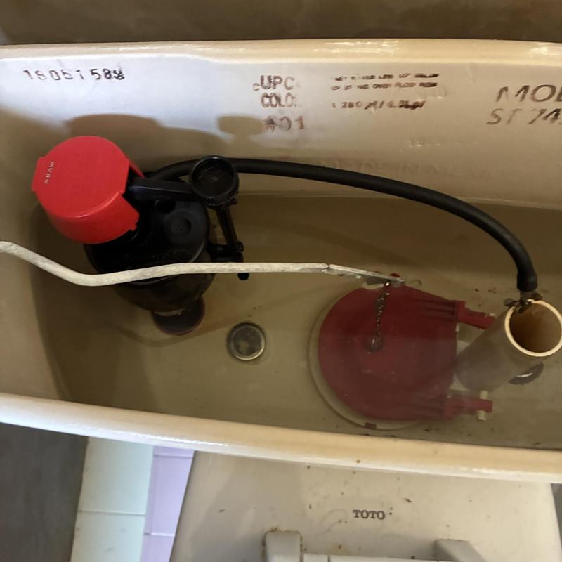 Toilet fill valve and flapper inside tank