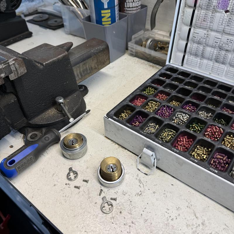 Cylinder lock pins and tools on locksmith workbench