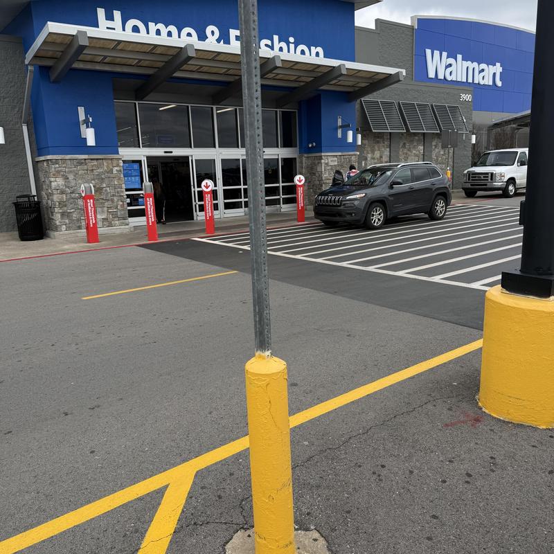 Walmart store entrance with parking and vehicles