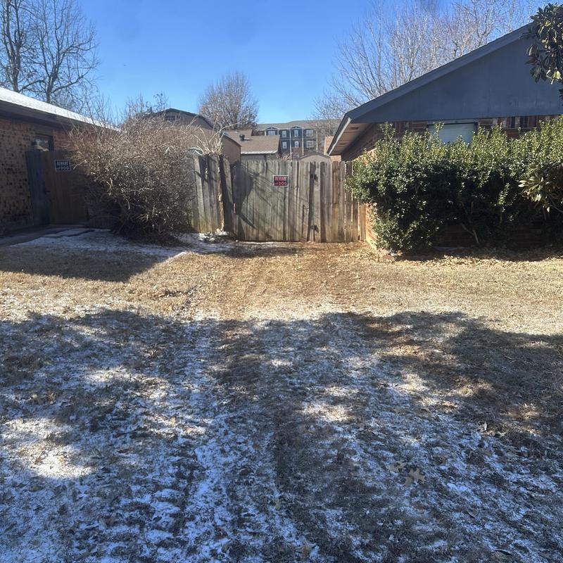 Sewer service line trench with tire tracks in yard