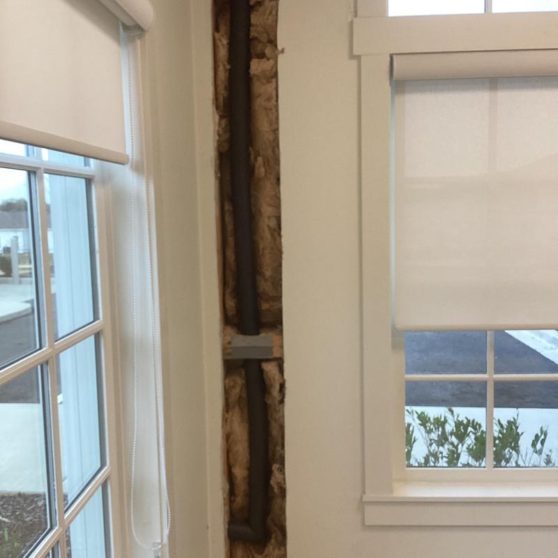 Hose bib piping insulated and secured inside wall cavity