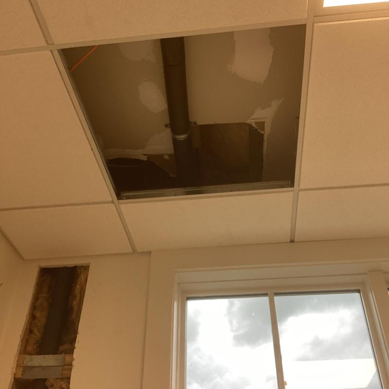 Ceiling pipe repair and insulation with hole cut in tile