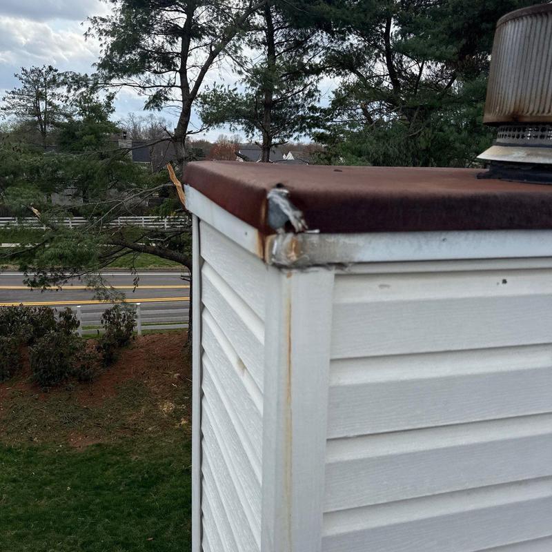 Chimney cap rust and damaged corner flashing inspection