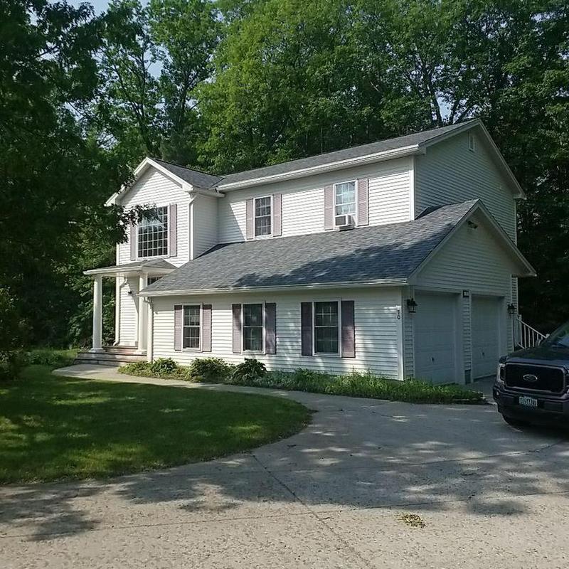 Architectural shingle roof on white two-story home