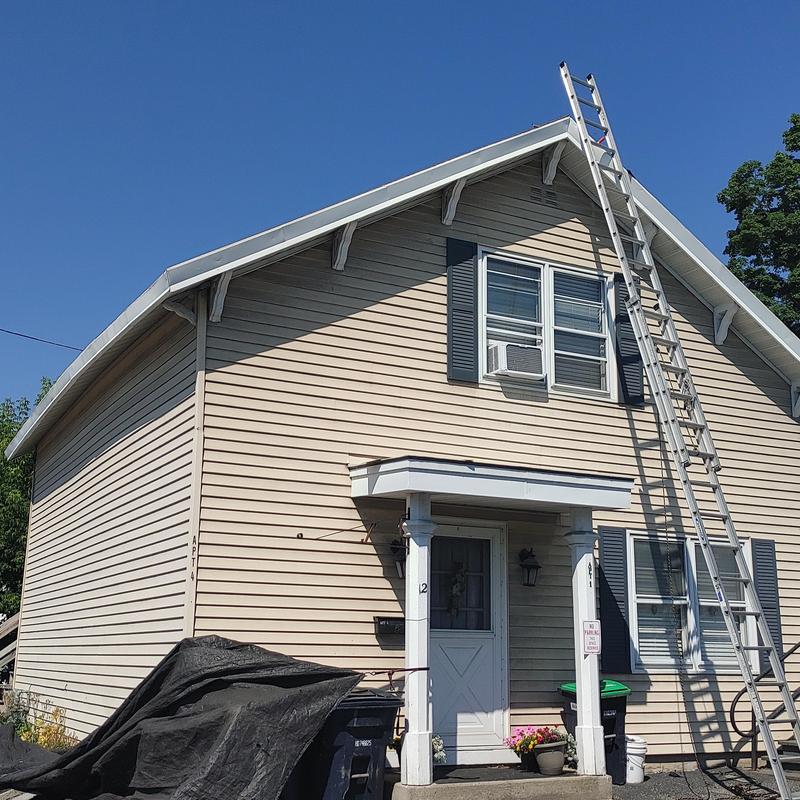 Asphalt shingle roof with ladder on residential home