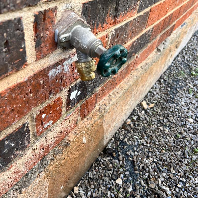 Frost proof sillcock valve on brick exterior wall