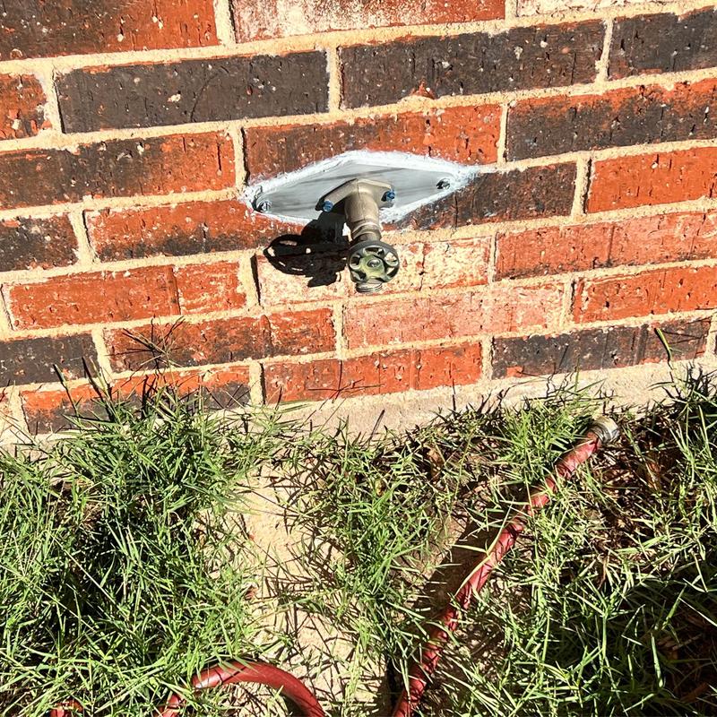 Frost proof sillcock valve on brick exterior wall