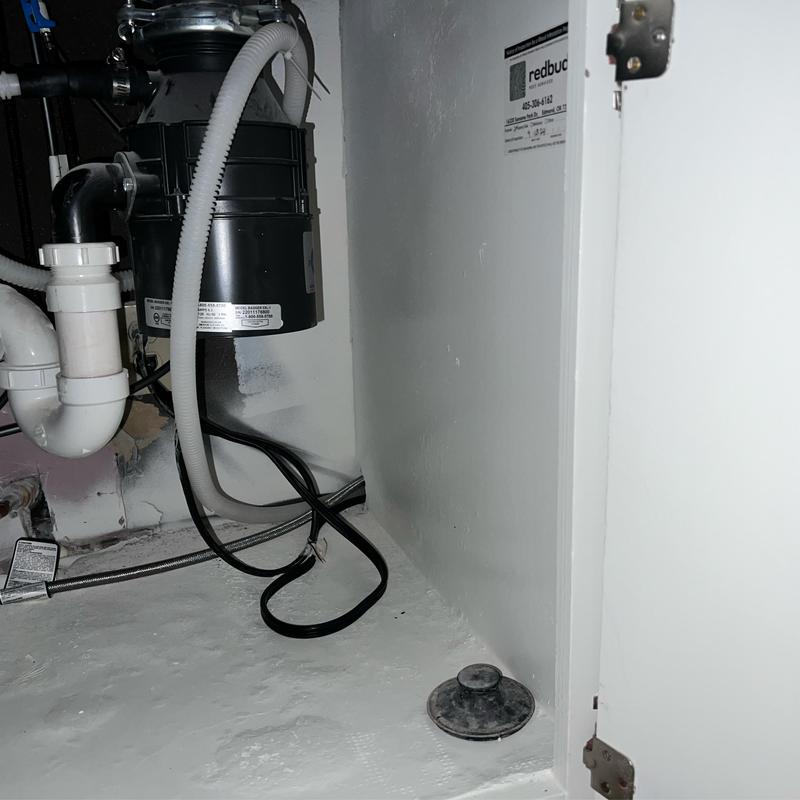 Garbage disposal unit with drain and plumbing connections
