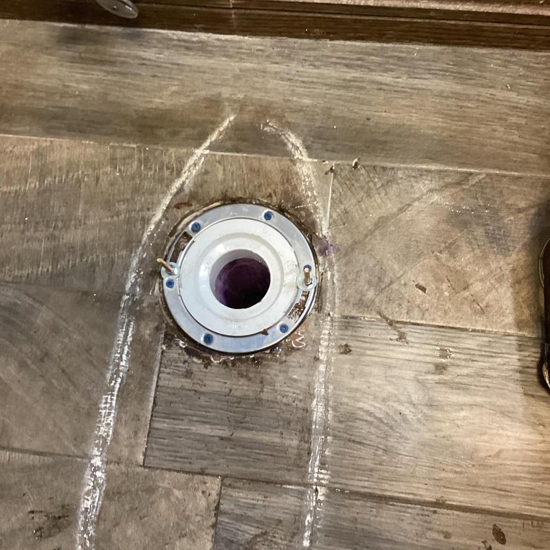 Toilet flange on wood floor with mounting screws