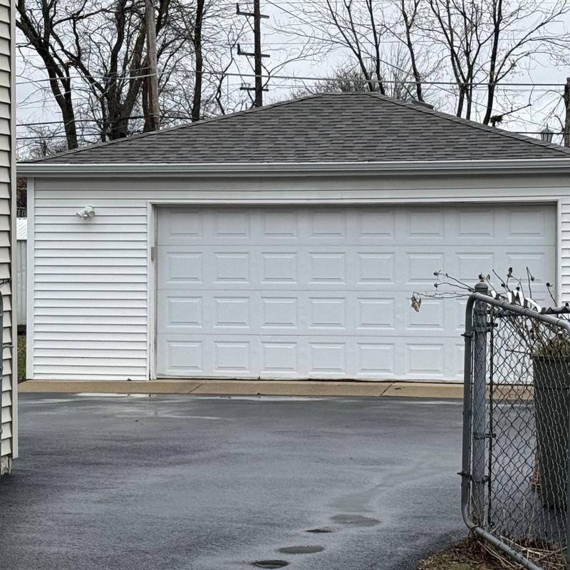 Garage door and roof shingles on detached garage