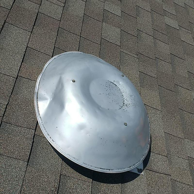 Metal skylight dome dented on asphalt shingle roof