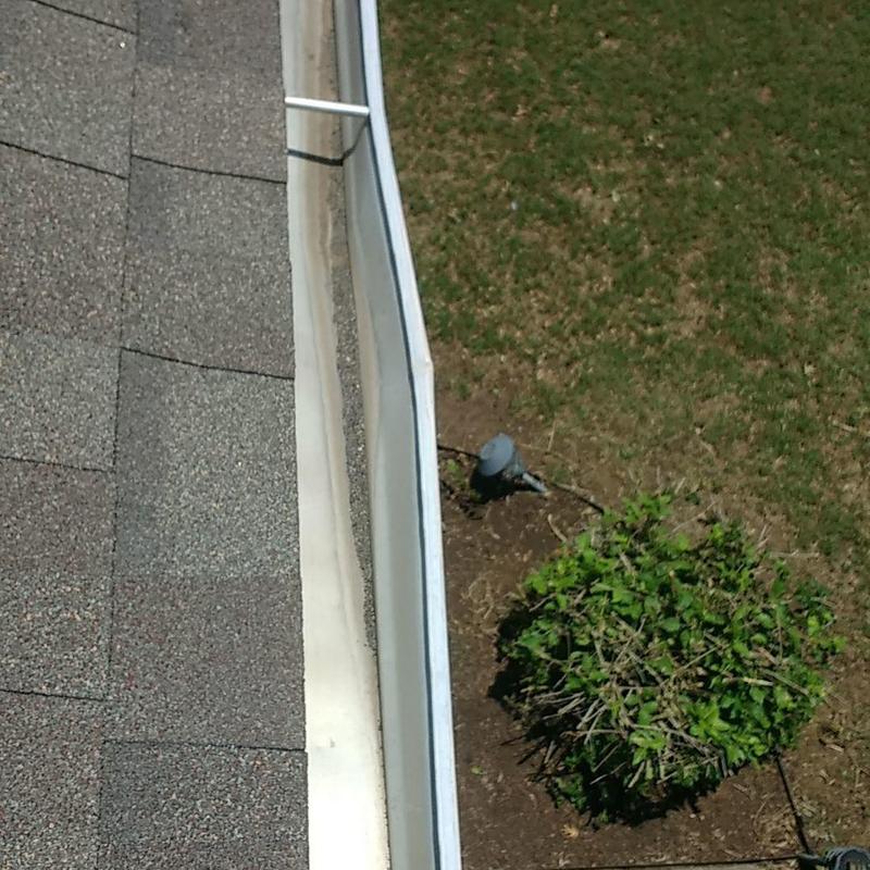 Gutter system alongside new shingle roof edge