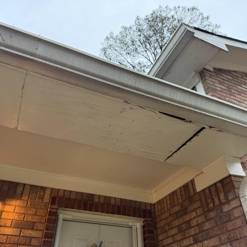 Wood fascia and soffit damage with gutter above