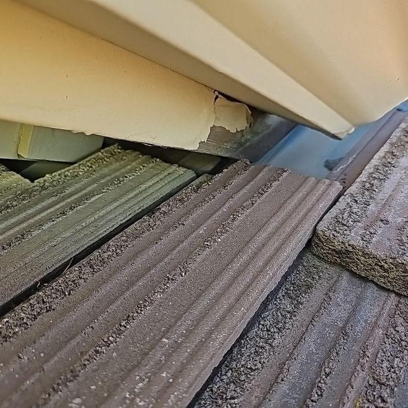 Tile roof with damaged flashing and displaced tiles Tile roof with damaged flashing and displaced tiles