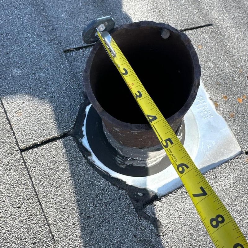 Roof vent pipe measurement with tape on shingle roof