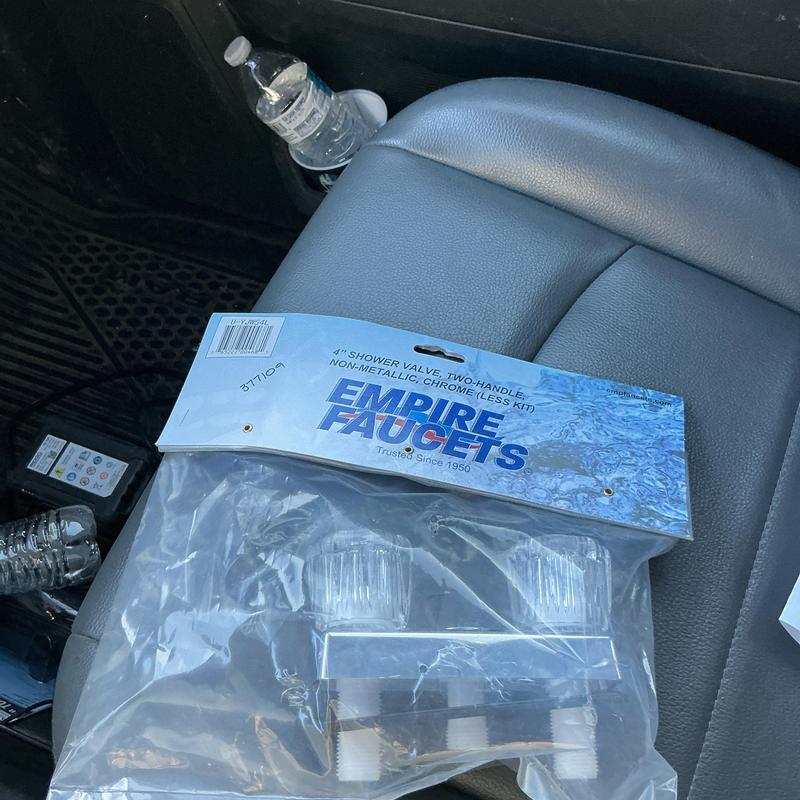 Shower valve two-handle chrome kit packaging on seat