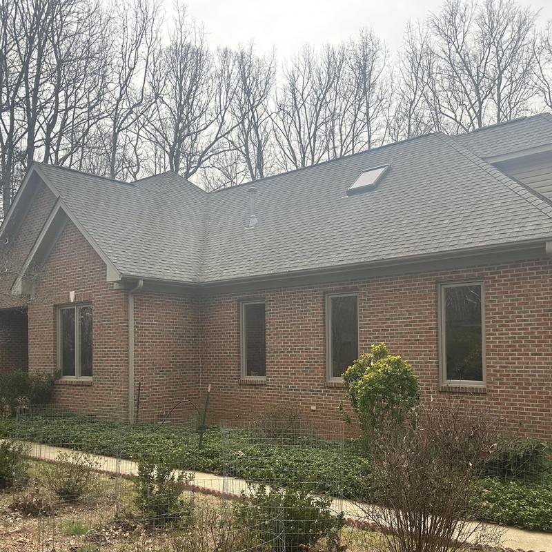 Asphalt shingle roof replacement on brick home exterior