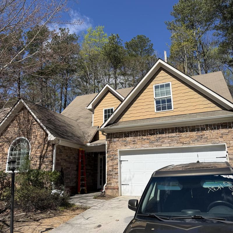 Gutters on two-story house needing cleaning in Loganville