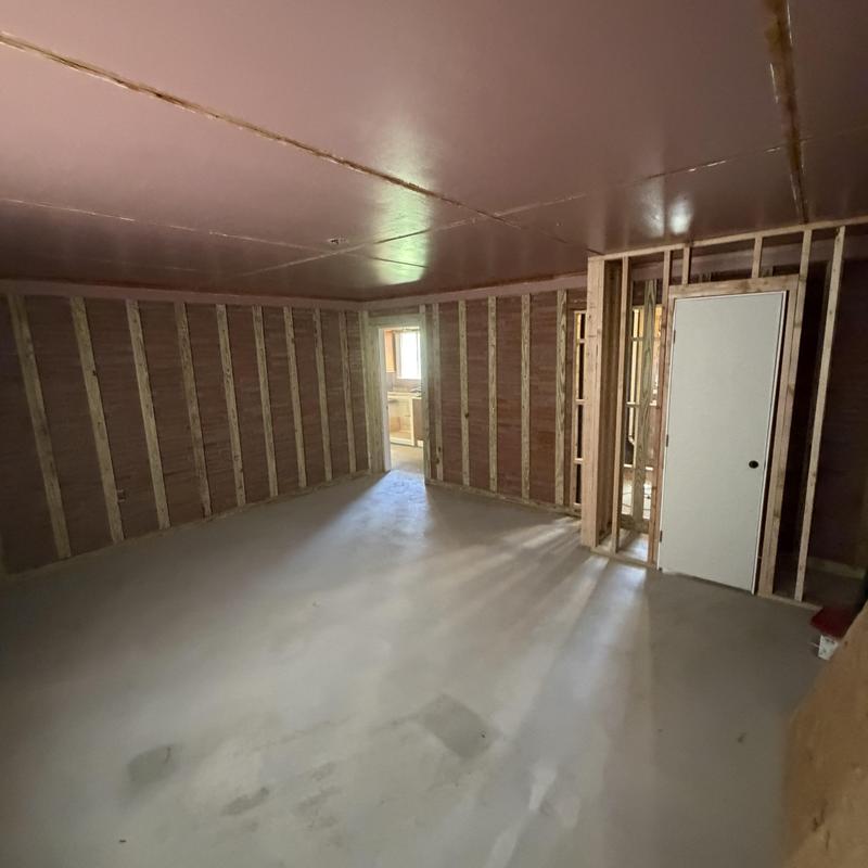 Garage framing and drywall installation in bedroom remodel