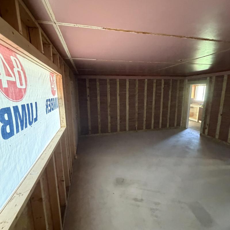 Garage framing and window installation in bedroom remodel