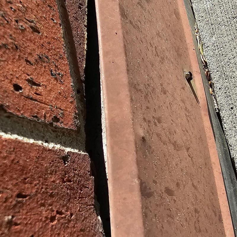 Brick wall and flashing gap close-up detail Brick wall and flashing gap close-up detail