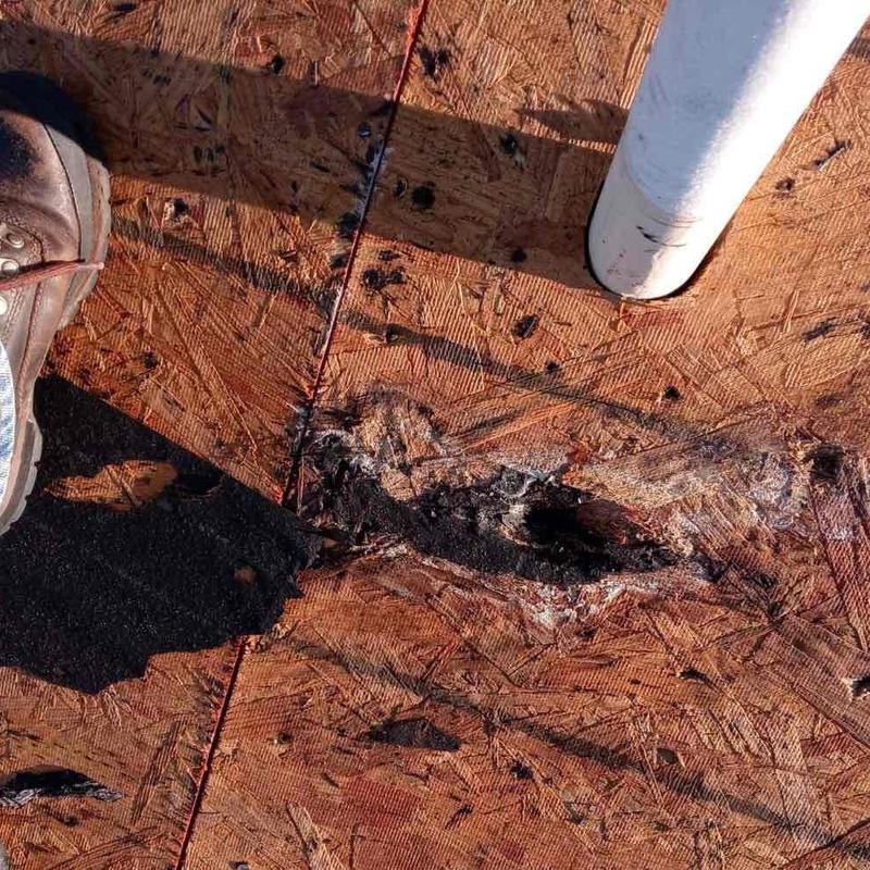 Damaged roof decking boards with pipe penetration nearby