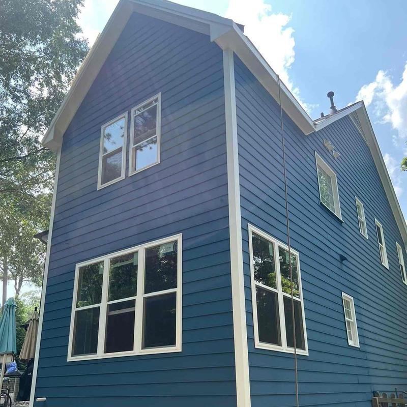Blue siding installation on two-story home exterior Blue siding installation on two-story home exterior