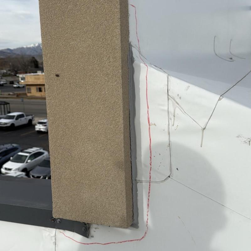 TPO commercial roof flashing with weld defects and markings