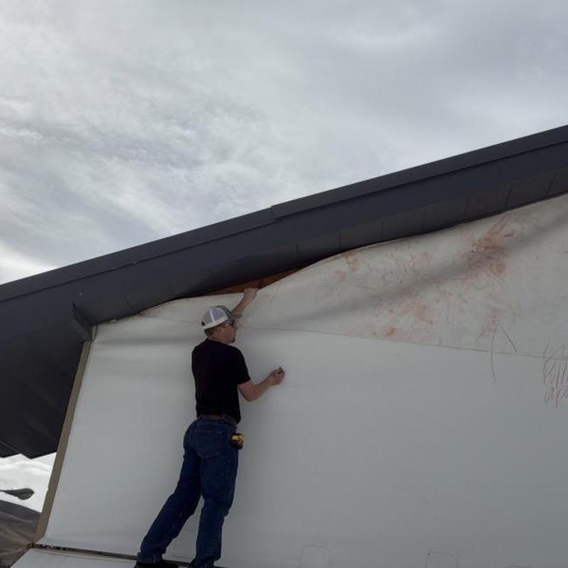TPO commercial roofing membrane inspection at gym building