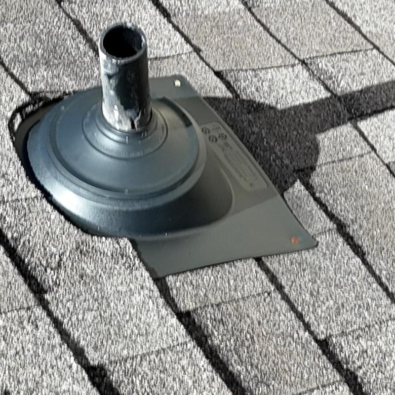 Pipe boot on asphalt shingle roof with damage visible