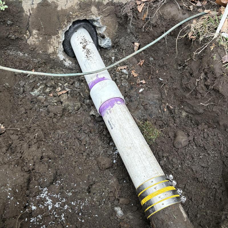 PVC sink drain pipe repaired at foundation wall excavation