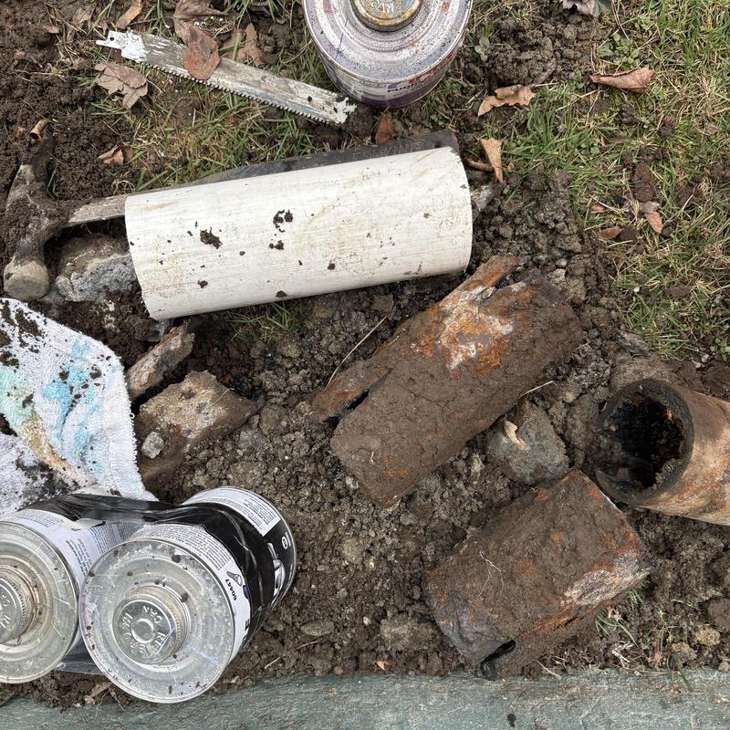 Cast-iron and PVC sink drain pipe replacement outdoors