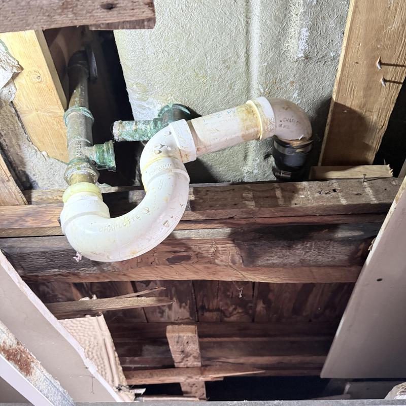 PVC drain pipe with elbow joints in ceiling cavity PVC drain pipe with elbow joints in ceiling cavity