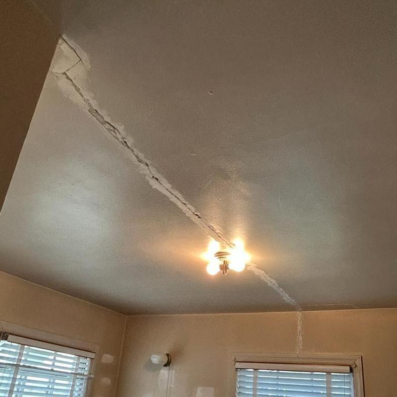 Ceiling crack repair in interior room with light fixture Ceiling crack repair in interior room with light fixture
