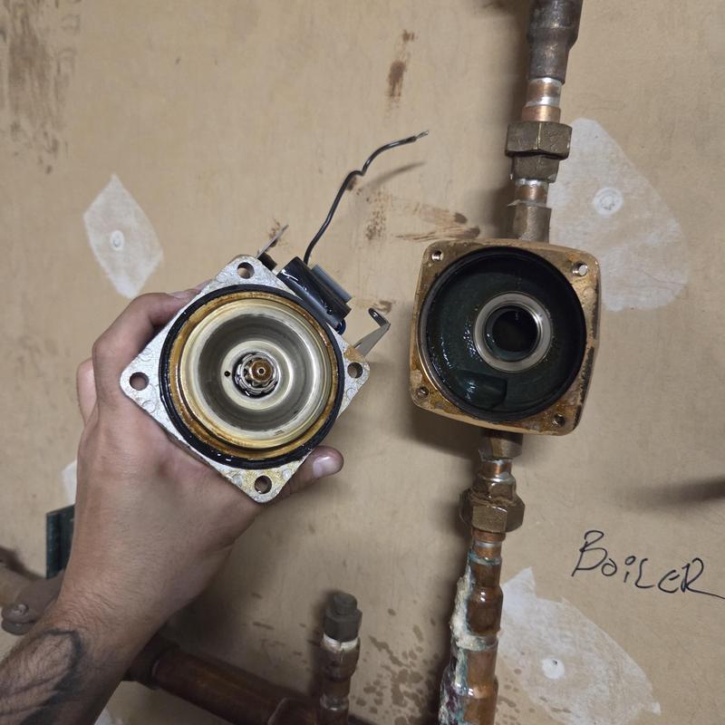 Boiler pump assembly disassembled with wiring and pipes