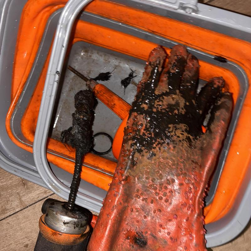 Laundry sink drain clog removal tool with debris