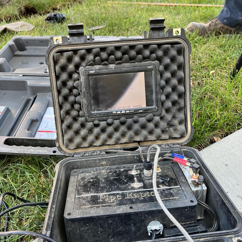 Main sewer line camera inspection equipment on grass